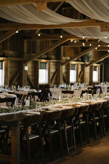 Reception inside Blue Heron Barn with warm lighting and rustic décor.