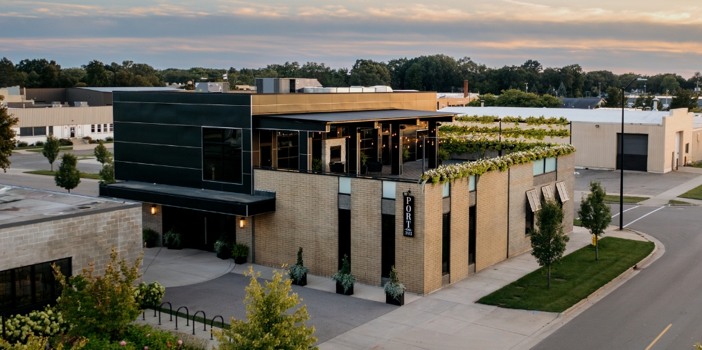 Exterior view of Port 393 wedding venue in Holland, Michigan featuring a modern industrial design and rooftop vineyard.